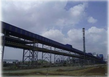Long belt conveyor gallery running to a power plant stack